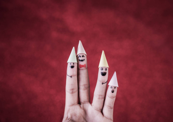 Finger with emotion on red background - Foto, afbeelding