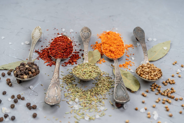Variety of herbs and spices on slate background. - Valokuva, kuva