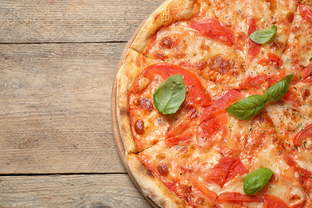Delicious pizza Margherita on wooden table, top view. Space for text - Фото, зображення