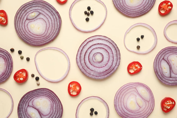 Flat lay composition with cut onion and spices on beige background - Valokuva, kuva