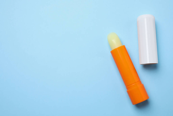 Hygienic lipsticks on light blue background, flat lay. Space for text - Foto, Bild