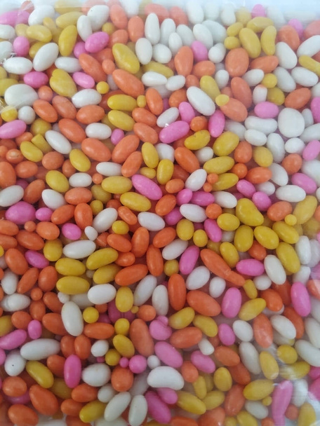 Крупный план пластиковой упаковки сахарных семян фенхеля с сахарным покрытием во рту
 - Фото, изображение