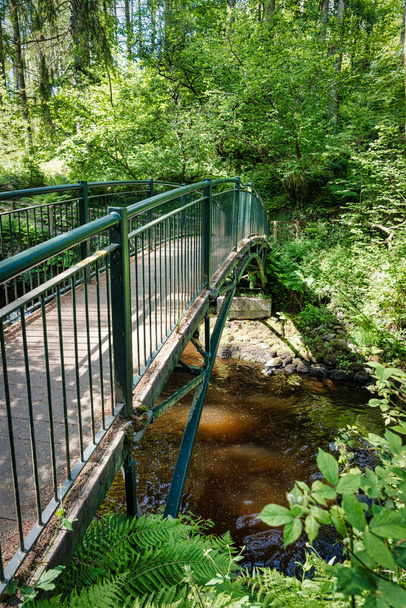 One of the bridges that criss cross the stream and  waterfalls in Glenariff Forest Park in Northern Ireland - Photo, Image