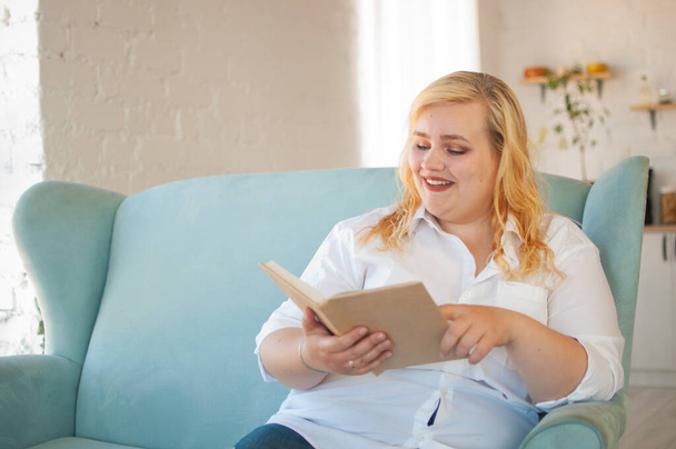 Young overweight woman reads paper book, rest alone, self-development - Foto, Imagem