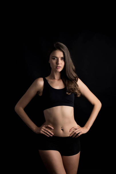 Beautiful woman with healthy body on black background - Foto, Imagen