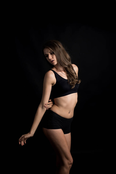 Beautiful woman with healthy body on black background - Fotografie, Obrázek