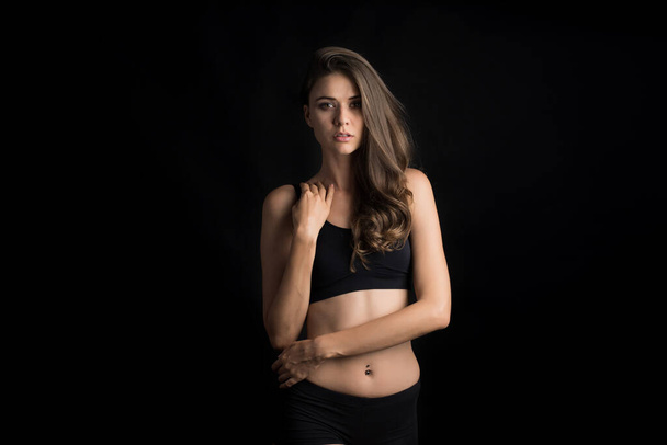 Beautiful woman with healthy body on black background - Foto, afbeelding