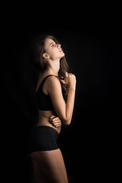Beautiful woman with healthy body on black background - Zdjęcie, obraz