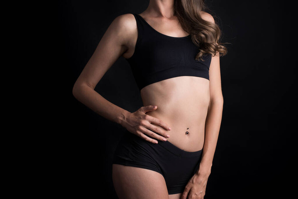 Beautiful woman with healthy body on black background - Fotoğraf, Görsel