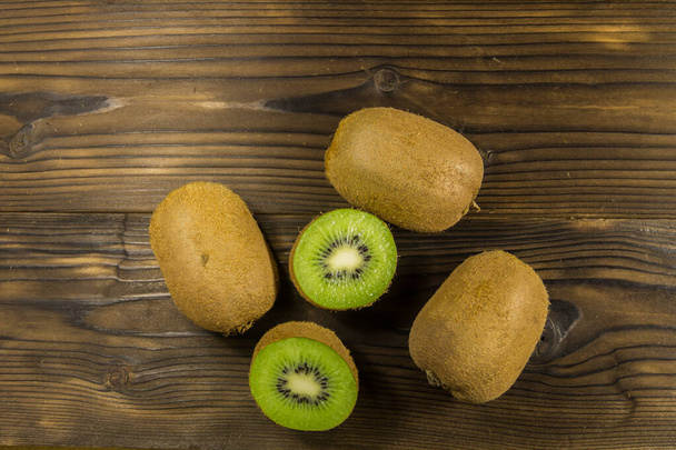 Kiwi fruits on wooden table. Top view, copy space - Fotografie, Obrázek