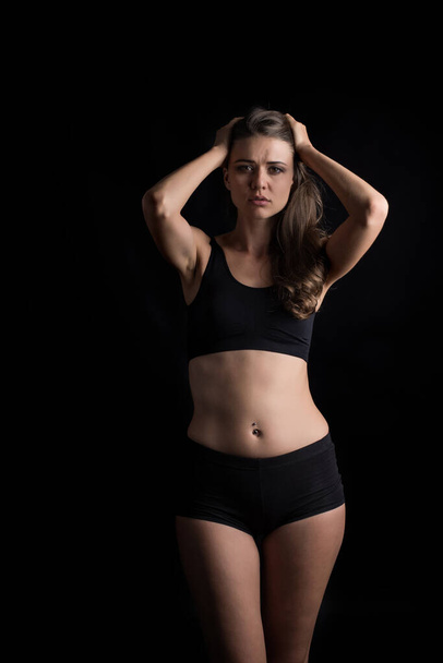 Beautiful woman with healthy body on black background - Φωτογραφία, εικόνα