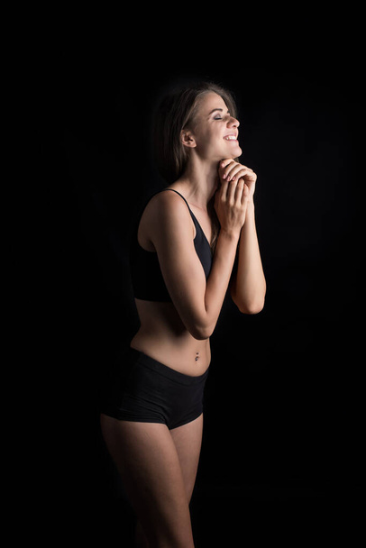 Beautiful woman with healthy body on black background - Foto, immagini