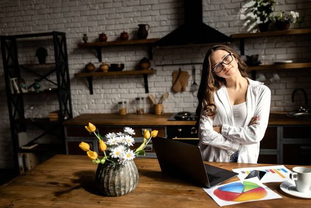 young woman working  with laptop on kitchen  - Zdjęcie, obraz