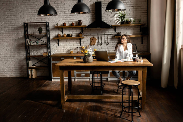 young woman designer working  with laptop on kitchen  - Valokuva, kuva