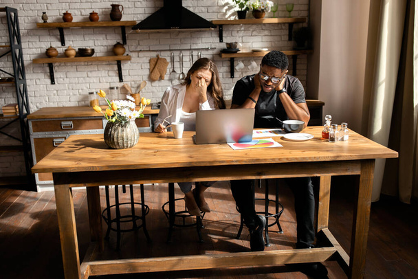 Young couple  of designers  with laptop on kitchen  - Valokuva, kuva