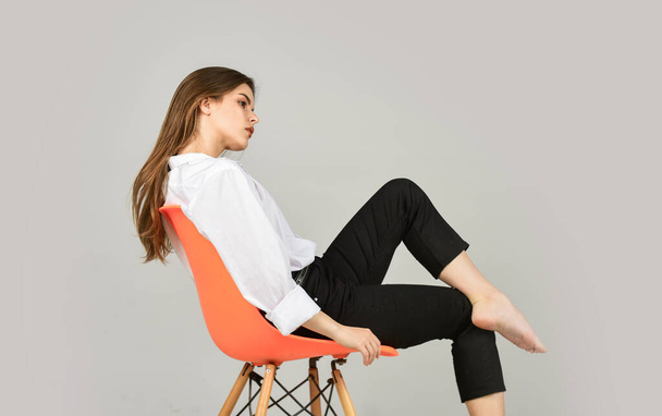 female sit on office chair. beauty and fashion. girl with natural makeup. sexy woman isolated on white. businesswoman in shirt. woman with sensual look. fashion model looking elegant. Pure beauty - Valokuva, kuva
