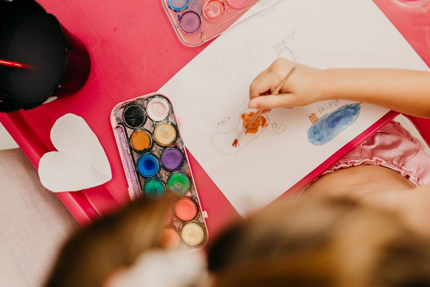 A child drawing with colorful paints on the paper - Photo, Image