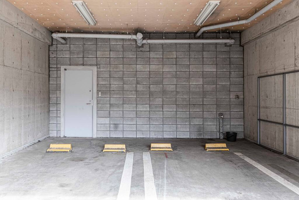 Underground car parking lot. Indoor parking area. Concrete basement floor parking garage - Photo, Image