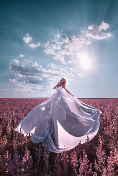 Beautiful woman in pink field - Valokuva, kuva