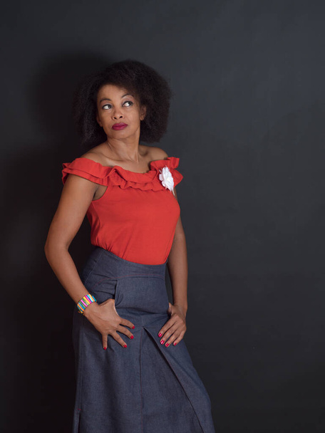 Vertical portrait of an  attractive African American woman wearing a red summer top  with a wondering look - Foto, immagini