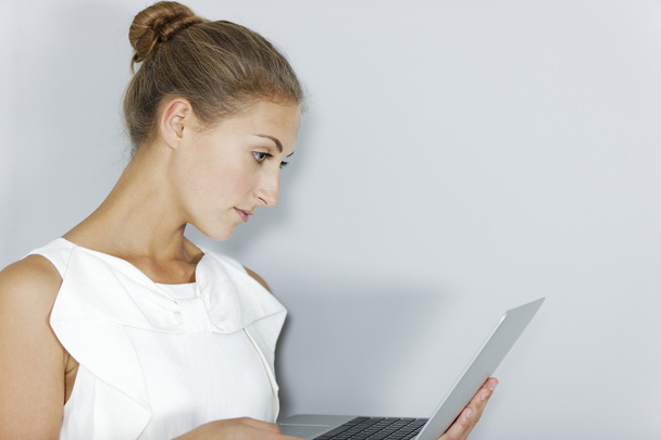 Business woman holding laptop - 写真・画像