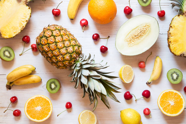 Tropical fruit on white wooden background - Фото, зображення