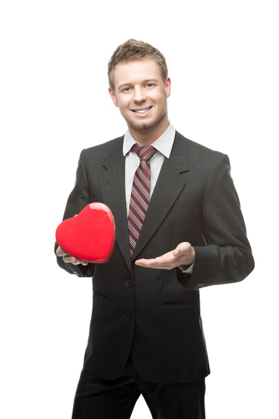 cheerful businessman holding red heart - Фото, изображение