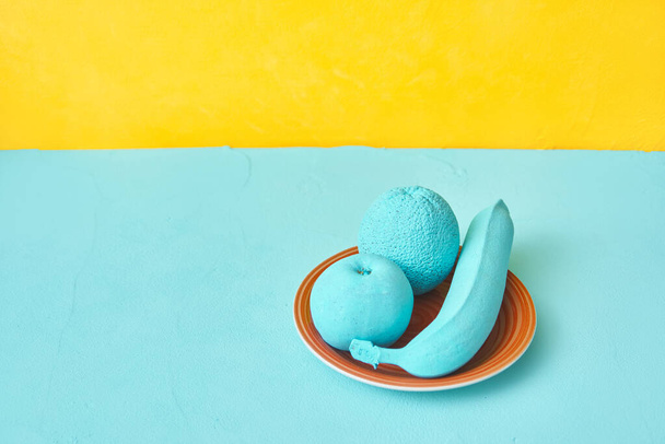 painted banana orange apple on a plate. creativity design concept - Fotó, kép
