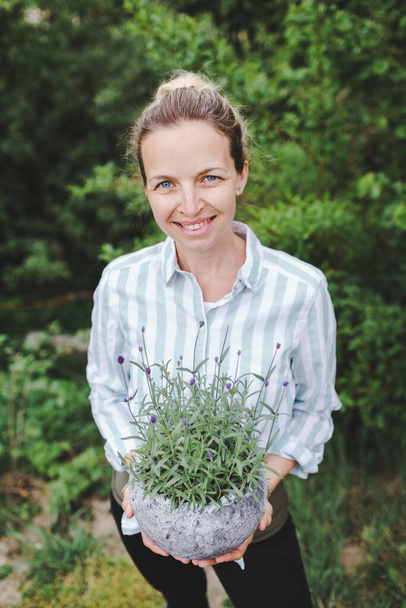 pretty young woman is posing with big and fresh lavender - 写真・画像