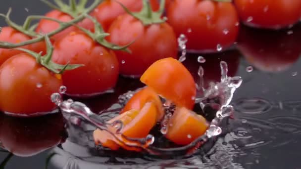 Slices of Ripe Tomato Falls on the Table, Splashing Drops. Slow Motion. - Video, Çekim