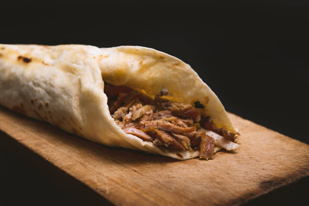 Doner Kebab Gyros Shawarma beef or chicken roll sandwich on wooden background - Photo, image