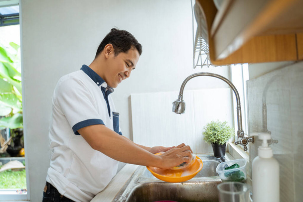man washing dishes - Photo, Image
