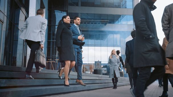 Diverse and Multicultural Office Managers and Business People Commute to Work in the Morning or from Office on a Sunny Day on Foot. Female and Male are Talking and Smiling on Their Way from Office. - Foto, Imagen