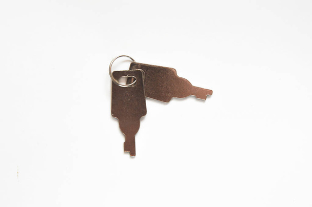 two small keys to the lock on a white background. - Foto, imagen