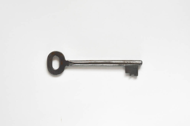 the key to the front door. metal key on a white background. - Foto, imagen