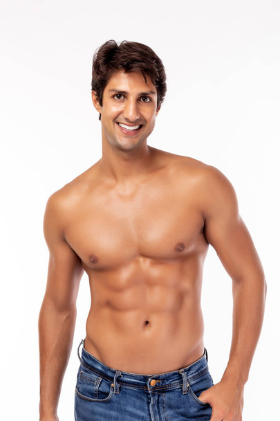 Portrait attractive young muscle man on white background. Handsome muscle guy has perfect body. Glamour male get successful of lose weight. He wear jeans, get shirtless. He get confident, happy. smile - Foto, Bild