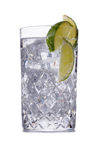 Orzeźwiający gin z tonikiem w krystalicznej galsss, nakręcony na biało z małym odbiciem - Zdjęcie, obraz