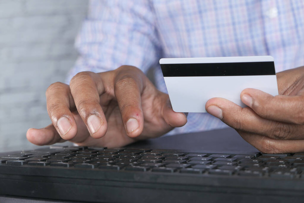 shopping online payment. Man holding credit card paying online  - Photo, Image
