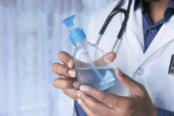 Doctor hand holding sanitizer gel with copy space  - Фото, зображення