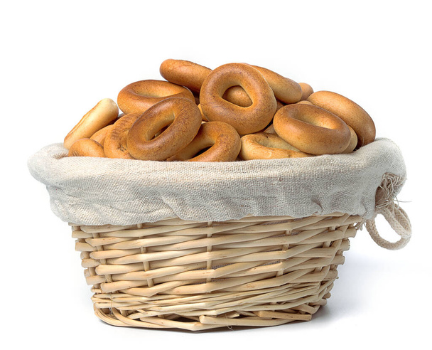 small bagels in a straw basket on a white background - Photo, Image