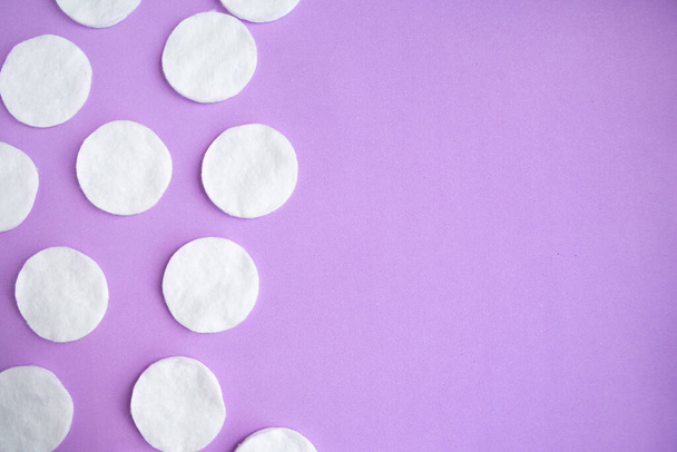 Cotton sponges pattern on purple background, minimal concept, copy space - Фото, изображение