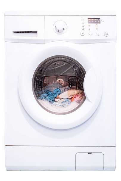 Laundry in a washing machine. Automatic washing machine. Isolate on a white background. Front view - Photo, Image