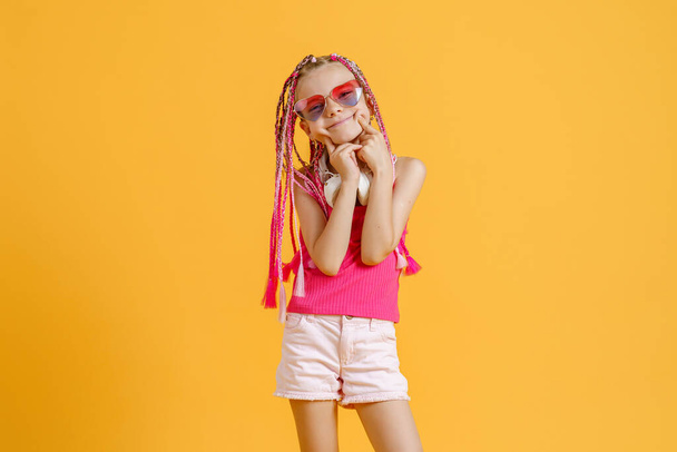 Crazy expressive trendy DJ girl in bright clothes, headphones and bright dreadlocks. Disco, party - Foto, Imagem