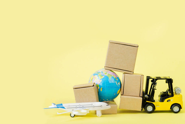 Mini forklift truck load cardboard boxes in the Airplane. Fast delivery of goods and products. Logistics, connection to hard-to-reach places. Banner, copy space. - Photo, Image