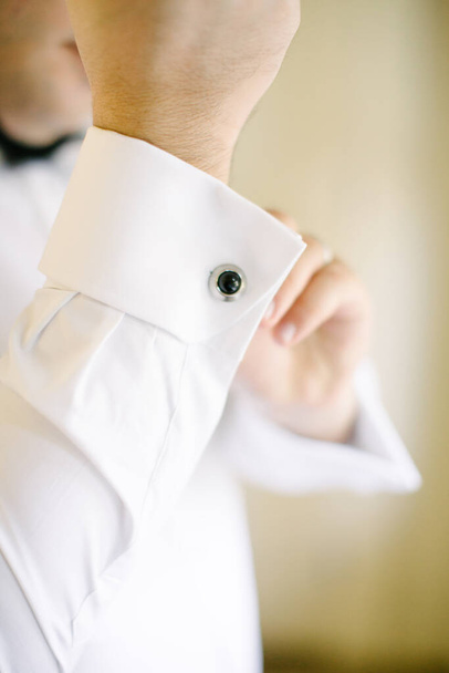 Groom tying cufflinks. Preparations for the wedding day. - Photo, Image