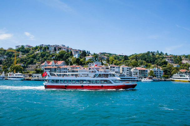 Beautiful scenery port with sightseeing boats in Istanbul background. Resort town side in Bosphorus Bridge, Turkey. - Photo, image