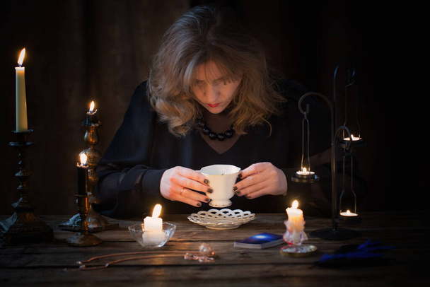 mature woman divines on coffee grounds - Valokuva, kuva