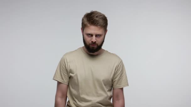 Bully angry bearded guy looking at camera mad aggressive, feeling crazy irritated and shouting furious, full of hate, experiencing strong emotions. indoor studio shot isolated on gray background - Footage, Video