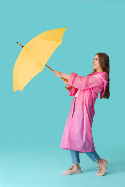 Beautiful woman with umbrella on color background - Foto, Imagen