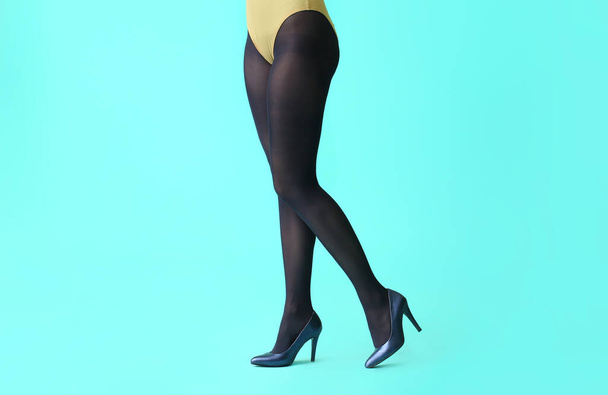 Beautiful young woman in tights on color background - Foto, imagen